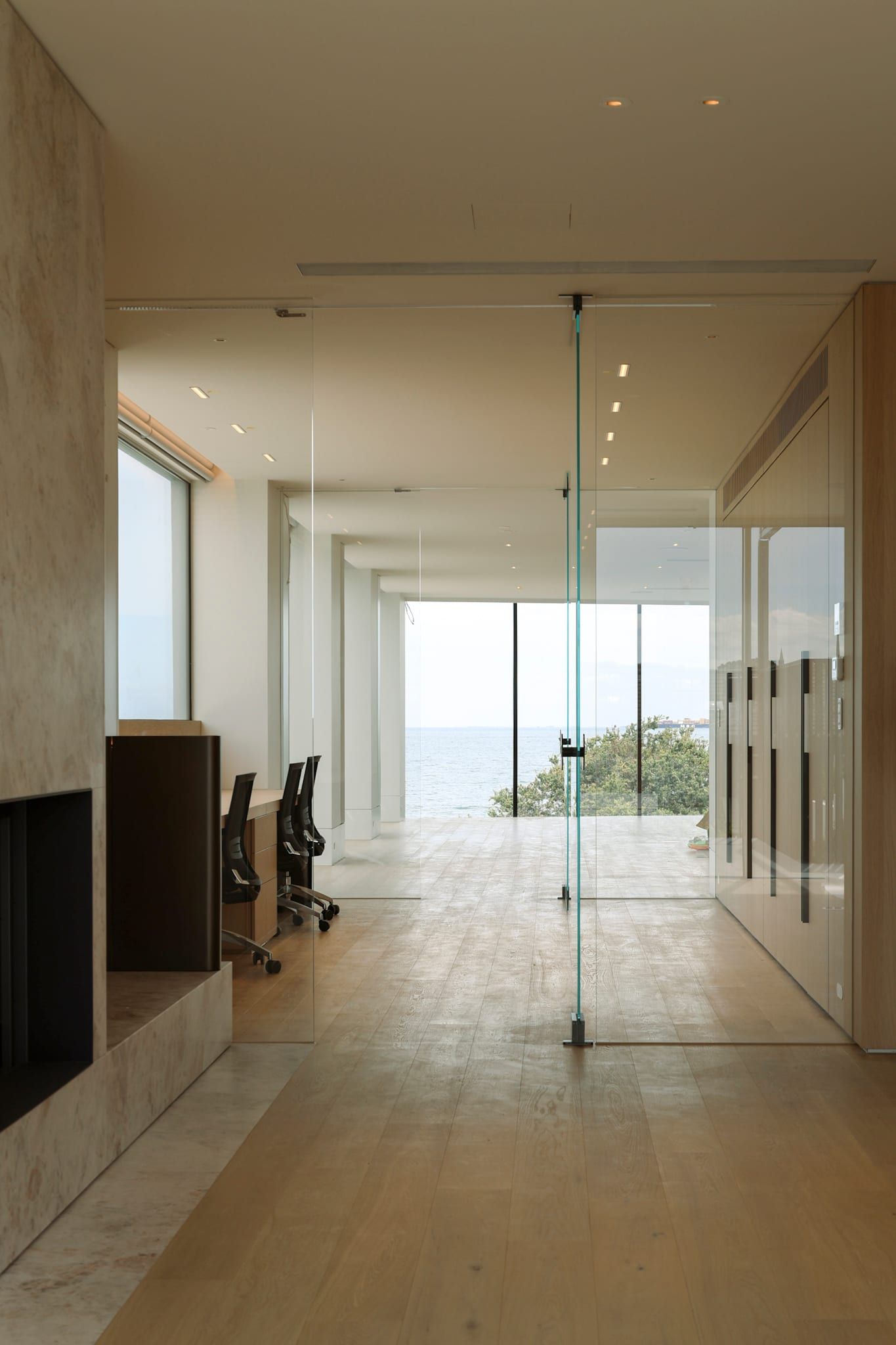 Living space opening to the bay, a ship on the horizon