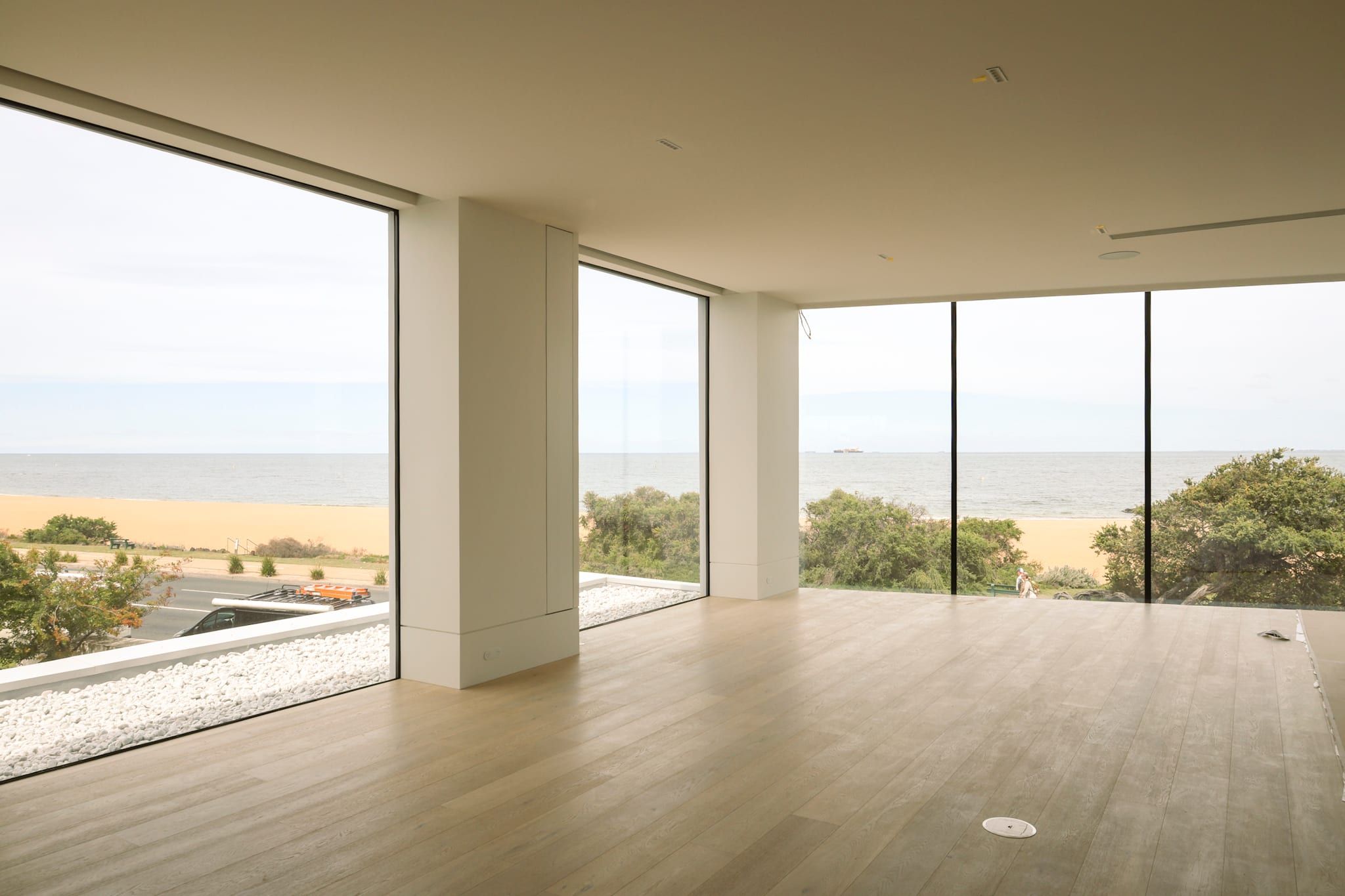Curved living space at Arc House looking out across the bay