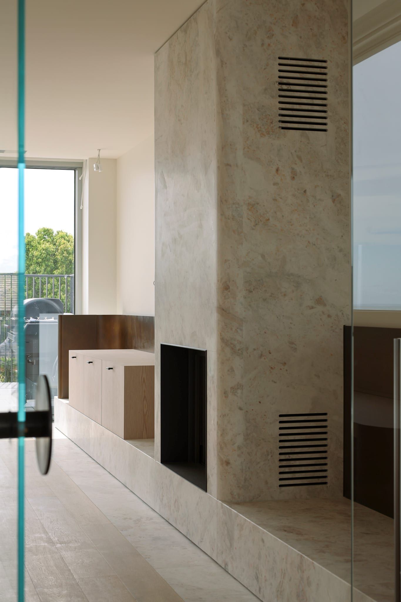 Stone fireplace clad as a full-height column with concealed vents