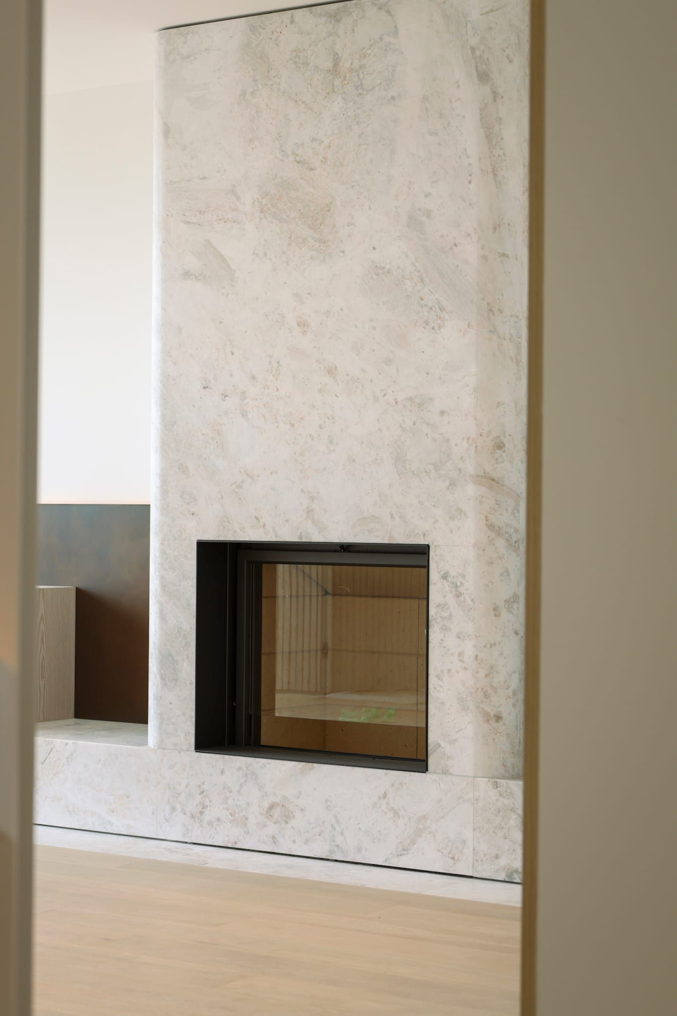 Stone fireplace detail with sculpted plaster surround