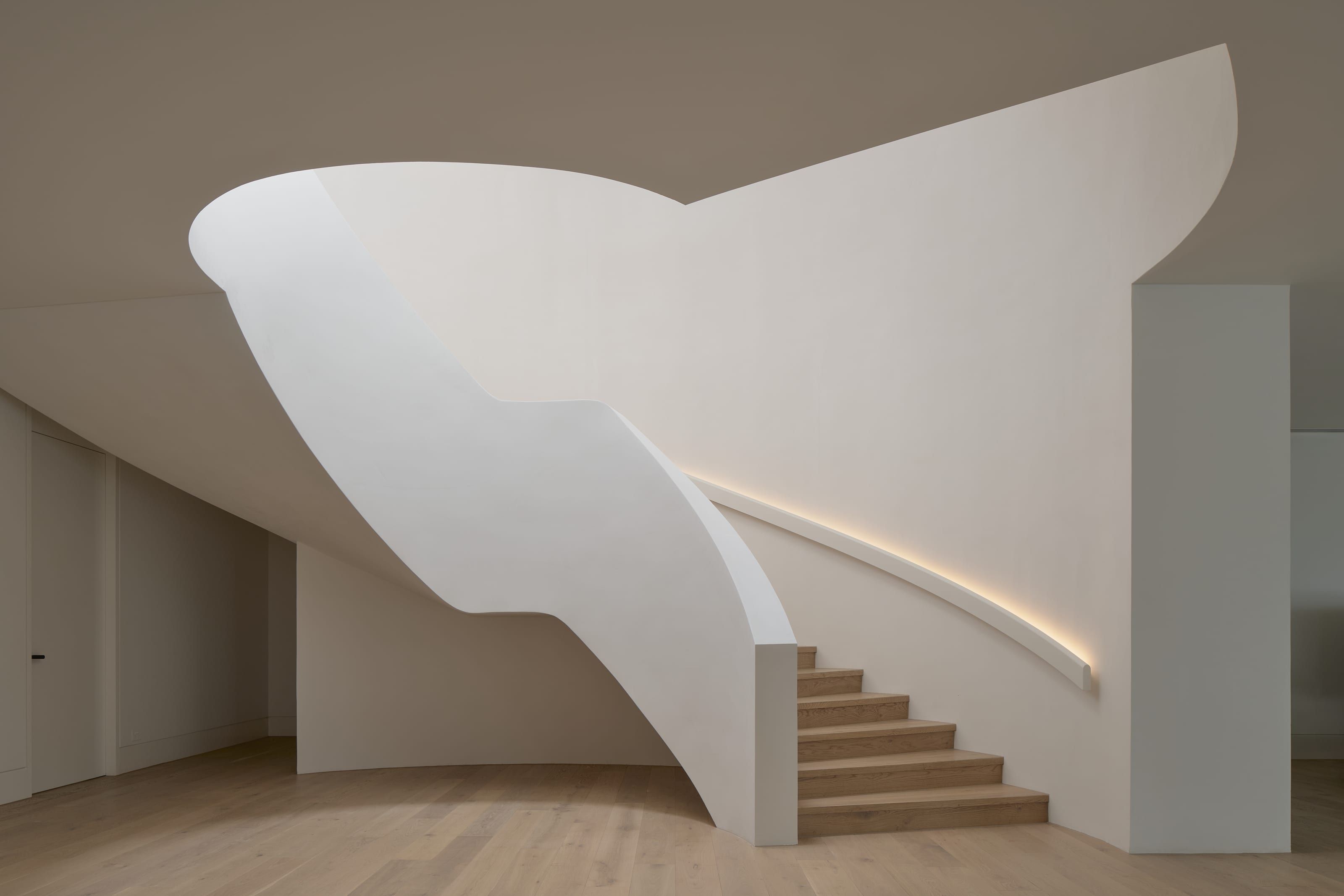 The finished curved Venetian plaster stair seen from below