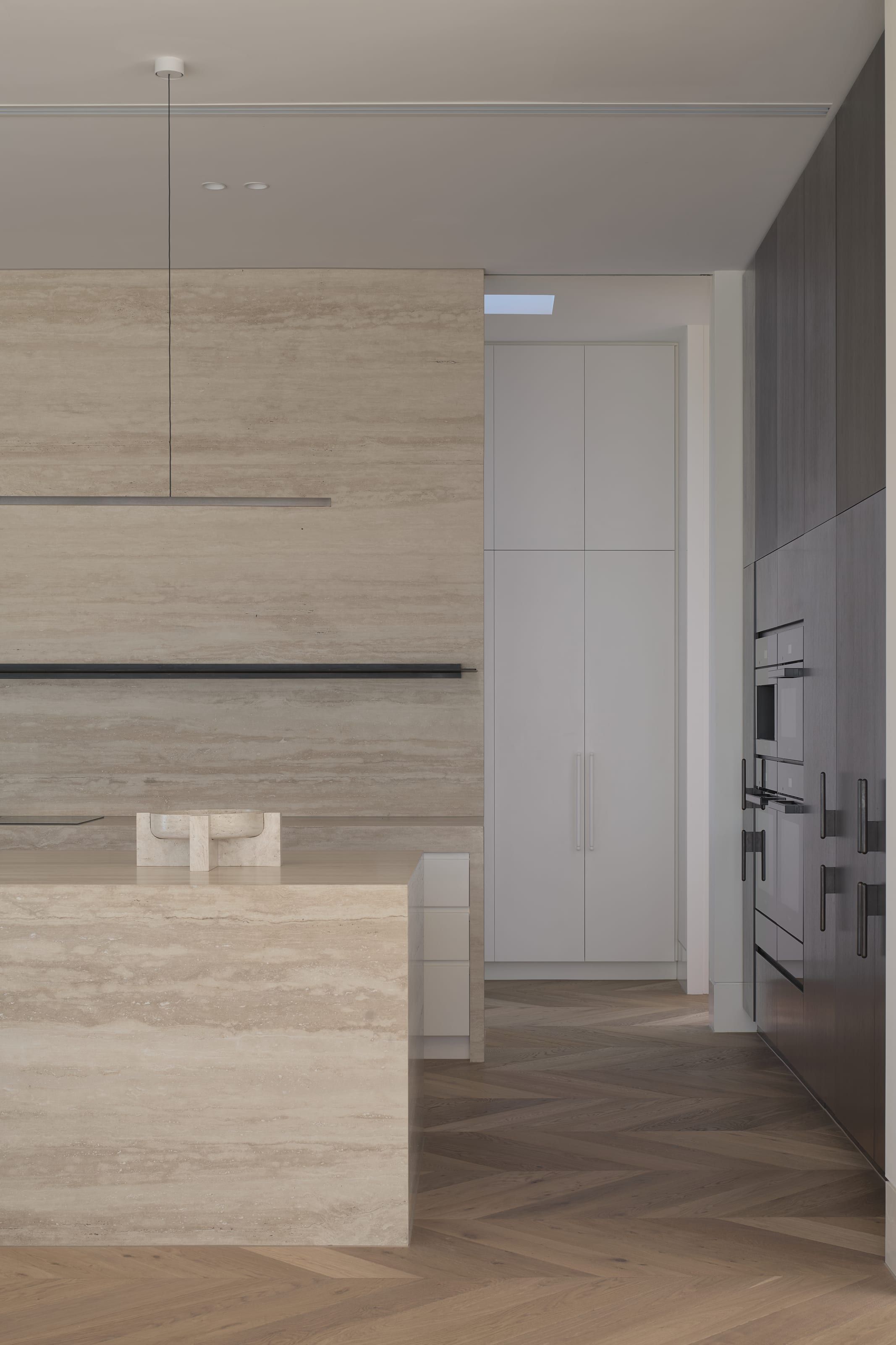 Kitchen island and joinery detail in travertine
